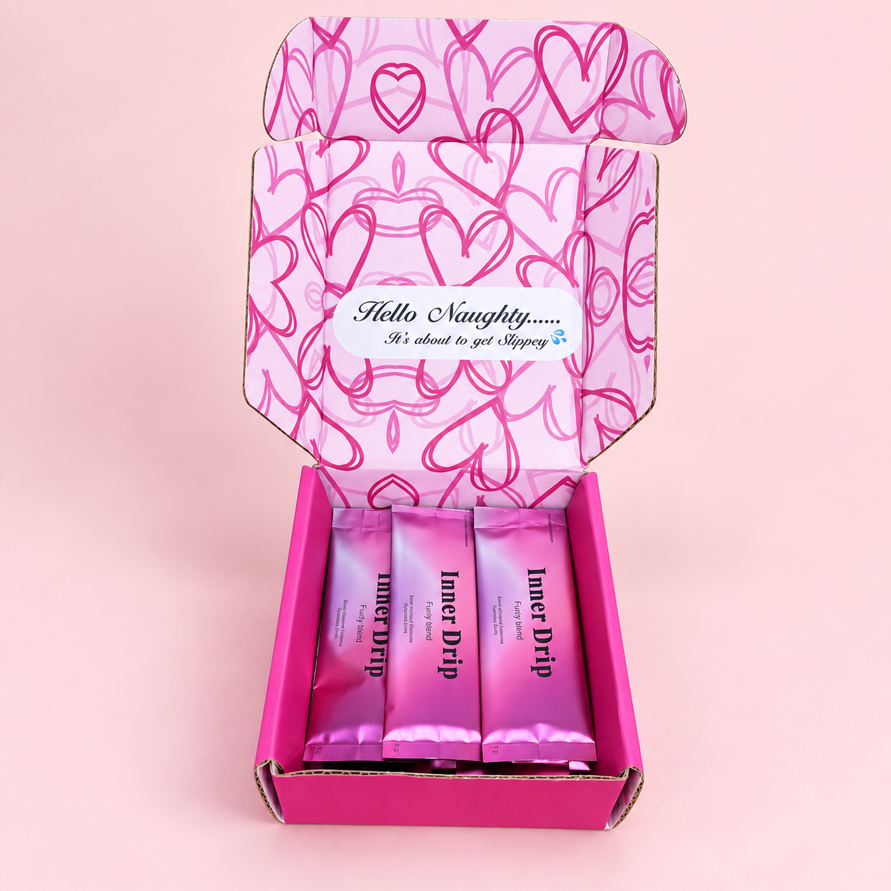 Open pink Inner Drip box with heart-patterned lid and sachets